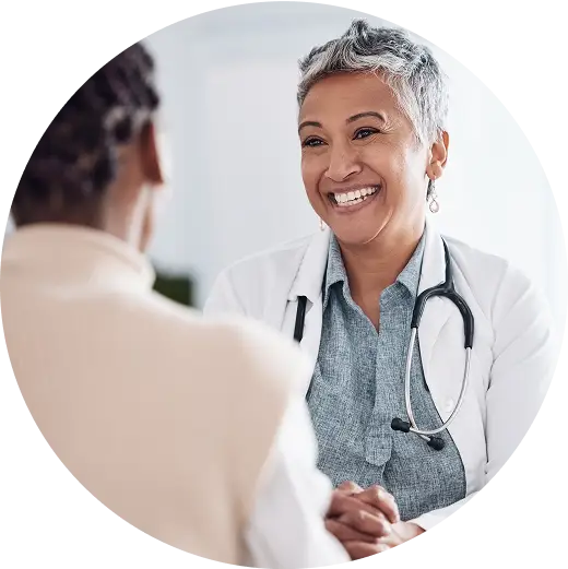 A photo of a doctor talking to a patient, smiling